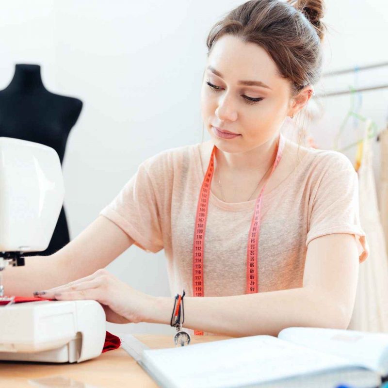 concentrated-woman-seamstress-sews-on-sewing-machine.jpg